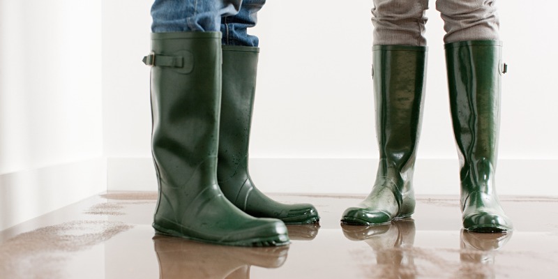 Couple in rain boots on flooded floor
