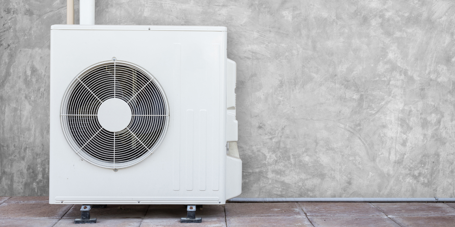 Heat Pump against Grey Wall - Understanding Heat Pumps: An FAQ Guide for Canadian Homeowners